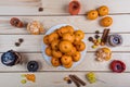 Holiday tangerines lie on wooden table.