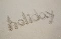 Holiday text written in the sand on the beach Royalty Free Stock Photo