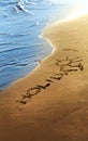 Holiday text written in sand on summer beach. Royalty Free Stock Photo