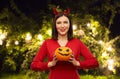 Woman in halloween costume of devil with pumpkin Royalty Free Stock Photo