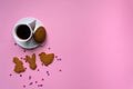 Holiday time concept. Flat lay style. Tasty breakfast. Pink background with place for text, cup of coffee and handmade cookies Royalty Free Stock Photo