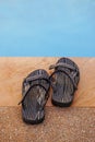 Holiday time. Sandal beside the swimming pool Royalty Free Stock Photo