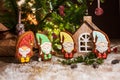 Holiday traditional food bakery. Four Gingerbread little fairytale gnomes in cozy decoration with garland lights