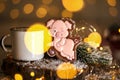 Holiday traditional food bakery. Gingerbread funny pink pig in cozy decoration with garland lights and cup of hot coffee