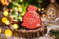 Holiday traditional food bakery. Gingerbread santa claus bag of christmas gifts in cozy warm decoration with garland lights