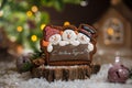 Holiday traditional food bakery. Gingerbread three fun snowmans in cozy warm decoration with garland lights