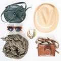 Holiday, travel background. Green cross bag, straw hat, retro brown sunglasses, grey scarf, retro camera, bocho bracelet.Flat lay,