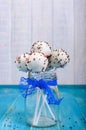 Holiday treats. Cake pops. Biscuit cakes in white chocolate glaze on a bright blue wooden background Royalty Free Stock Photo