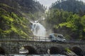 Holiday trip in motorhome, Caravan car Vacation. RV traveling on the road Latefossen Waterfall Odda Norway. Latefoss is a powerful