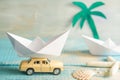 Holiday vacation concept with abstract origami boat and tropical beach