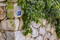 Holiday view with street number and stone wall Royalty Free Stock Photo
