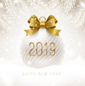 Holiday white bauble with glitter gold bow ribbon and New year 2019 number. Christmas ball on a snow.