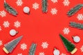 Holiday winter red. White snowflakes, fir tree, silver balls in Christmas composition on red background for greeting card. Xmas Royalty Free Stock Photo