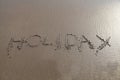 Holiday word written in sand Royalty Free Stock Photo