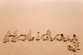 Holiday written in sand Royalty Free Stock Photo
