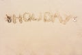 HOLIDAY written in the sand on the beach with copy space for t Royalty Free Stock Photo