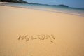 Holiday written in the sand at the beach waves in the background Royalty Free Stock Photo