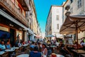 Holidaymakers in Antibes, Cote d`Azur, France sit at a terrace in a restaurant during the summer