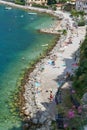 Holidaymakers on the beach of Malcesine on Lake Garda in Italy photographed from the tower of the Castello Scaligero