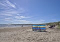 Holidaymakers enjoying the warm temperatures and clean Sand of Beadnell Bay in Northumberland.