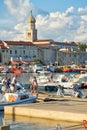 Holidaymakers in the harbor in front of the old town of Krk