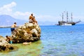 Holidaymakers sunbathe on a huge rock in the sea Alanya, Turkey