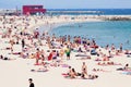 Holidaymakers sunbathing at Bogatell beach