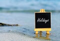 Holidays board on a beach. Royalty Free Stock Photo