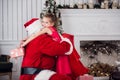 Holidays, celebration, childhood and people concept - smiling little girl hugging with santa claus over christmas tree Royalty Free Stock Photo