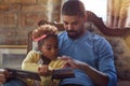 Holidays and celebration concept - Father and daughter reading Christmas fairy tales