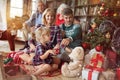 Holidays and celebration concept - happy family decorates a Christmas tree Royalty Free Stock Photo
