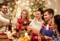 Friends celebrating christmas and drinking wine Royalty Free Stock Photo