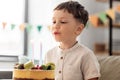 happy little boy blowing candles on birthday cake Royalty Free Stock Photo