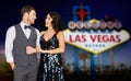 Happy couple at party over las vegas sign at night Royalty Free Stock Photo