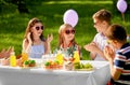 Happy kids with cake on birthday party in summer Royalty Free Stock Photo