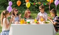 Happy kids with cake on birthday party at summer Royalty Free Stock Photo