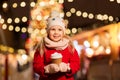 Happy girl with cup of tea at christmas market Royalty Free Stock Photo