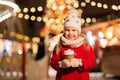 Happy girl with cup of tea at christmas market Royalty Free Stock Photo