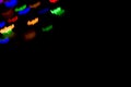 holidays, decoration and party concept - defocused bokeh multicolor lights in shape of bats for halloween background. copy space