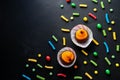 Holidays, decorations and party concept - Halloween cupcakes and candies with empty copy space on black background Royalty Free Stock Photo