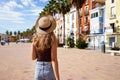 Holidays in Europe. Happy traveler girl visiting the colorful Spanish village with palm trees and beaches Villajoyosa, Alicante, Royalty Free Stock Photo