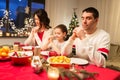 Family praying before meal at christmas dinner Royalty Free Stock Photo