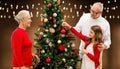 Happy family decorating christmas tree Royalty Free Stock Photo