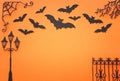 Holidays Halloween concept. haunted alley with vintage fence, street lamp trees and bats over orange background. Top view, flat Royalty Free Stock Photo