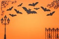 Holidays Halloween concept. haunted alley with vintage fence, street lamp trees and bats over orange background. Top view, flat