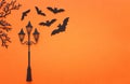 Holidays Halloween concept. vintage street lamp and bats over orange background. Top view, flat lay Royalty Free Stock Photo