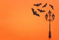 Holidays Halloween concept. vintage street lamp and bats over orange background. Top view, flat lay Royalty Free Stock Photo