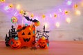 Holidays image of Halloween. Pumpkins, bats, treats, paper gift bag over wooden table