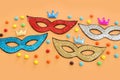 Holidays image of mardi gras masquarade sequins masks over yellow background. view from above