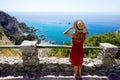 Holidays in Italy. Full length of young woman with hat in Capo Vaticano on the Coast of the Gods, Calabria, Italy